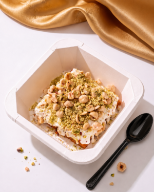 coconut basbousa with cream & premium nuts | طبق بسبوسة جوز الهند بالقشطة والمكسرات